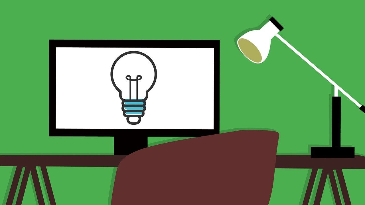 A graphic illustration of a home office setup with a computer monitor displaying a light bulb icon, accompanied by a desk lamp and a chair against a green background.